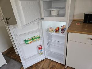 a white refrigerator with its door open in a kitchen at Gästewohnung Rauw in Saint-Vith +13 photos