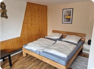 a bedroom with a large bed in a room at Gästewohnung Rauw in Saint-Vith