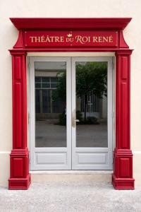 a red entrance to a building with a door at Suite historique classée Avignon intra-muros in Avignon