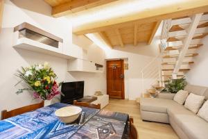 a living room with a table and a couch at La Casa della Musica by Le Case di Tati in Carpasio