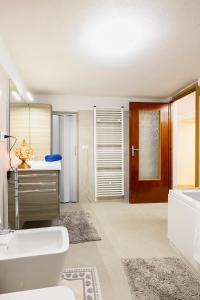 a bathroom with a tub and a sink and a toilet at La Casa della Musica by Le Case di Tati in Carpasio +39 photos