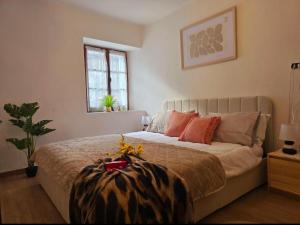 a bedroom with a large bed with orange pillows at Alpine View Varzo - Train Station in Varzo