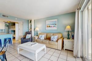 a living room with a couch and a table at Plantation Palms 6305 in Gulf Highlands +32 photos