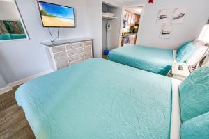 a bedroom with two beds and a television in it at Prime Ocean Frontage The Pavilion in Myrtle Beach