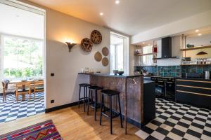 a kitchen with a counter and bar with stools at chalet baron in Lormont