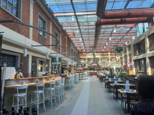 a restaurant with tables and chairs in a building at Casa Torino Lingotto centro fiere, metro, Inalpi Arena,Centro Congressi, Ospedale Molinette, Politecnico in Turin