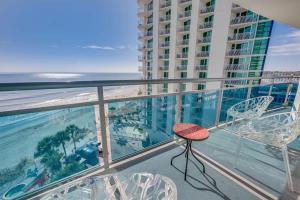 a balcony with chairs and a view of the ocean at Amazing Oceanfront 2BR condo with pools and views in Myrtle Beach
