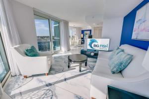 a living room with white chairs and a table at Amazing Oceanfront 2BR condo with pools and views in Myrtle Beach