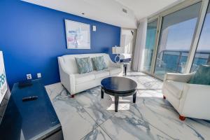 a living room with a white couch and a table at Amazing Oceanfront 2BR condo with pools and views in Myrtle Beach
