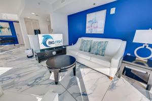 a living room with a white couch and a blue wall at Amazing Oceanfront 2BR condo with pools and views in Myrtle Beach +69 photos