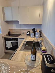 a bottle of wine sitting on a counter in a kitchen at Ty Joty in Perros-Guirec