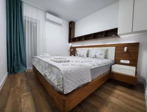 a bedroom with a large bed in a room at Apartments Bulatovic in Budva