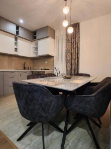 a dining room with a table and chairs at Apartments Bulatovic in Budva +11 photos