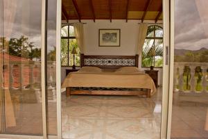 a bedroom with a bed in a room with windows at Costa del Llano Hotel Campestre in Villavicencio +45 photos