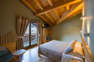 a bedroom with a bed and a large window at Alpen Chalet - Charme Mountain Hotel - in Schilpario +90 photos