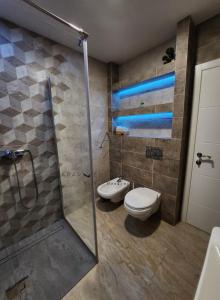 a bathroom with a shower and a toilet and a sink at Apartments Bulatovic in Budva