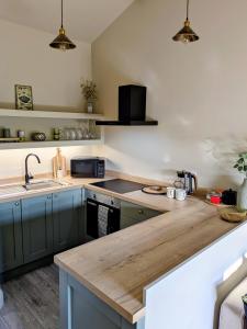 a kitchen with a sink and a counter top at Pudsey Loft Apartment in Pudsey