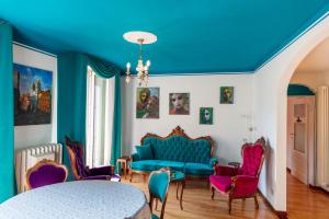 a living room with a blue couch and chairs at Appartamento Splendore in Bellagio +48 photos