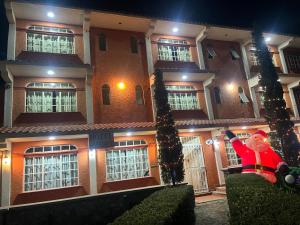 a santa claus sitting in front of a building at Hotel LaLoma in San Miguel Regla