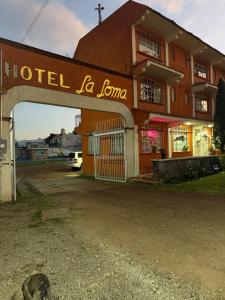 a hotel la joma sign in front of a building at Hotel LaLoma in San Miguel Regla +3 photos