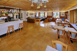 a restaurant with a bar and tables and chairs at Pension Haus Sonneck in Wildemann