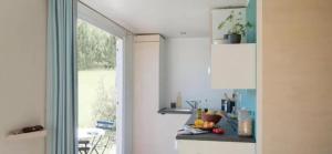 a kitchen with a counter with fruit on it at ZEcamping 3 étoiles familial pet friendly avec piscine et restaurant in Sandrans