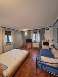 a bedroom with a large bed and a television at Casa Rural Mirabueno in Cuenca