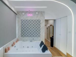 a bathroom with a large white tub in a room at Escapade à deux à 10mn de Paris in Gentilly