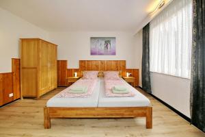 a bedroom with two beds and a large window at Pension Haus Sonneck in Wildemann