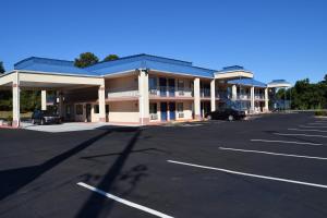 a parking lot in front of a hotel at Royal Inn & Suites in Douglasville