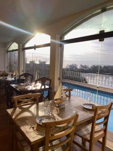 a restaurant with a table and chairs and a pool at Restau de Marambaia in Barra de Guaratiba