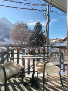 a table and chairs on a patio with a view at Lo noú b&b in Aosta +10 photos
