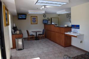a waiting room with a counter and chairs in a hospital at Royal Inn & Suites in Douglasville