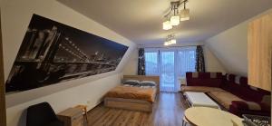 a small room with a bed and a couch at Willa na Bartkowym Wierchu in Gliczarów Górny