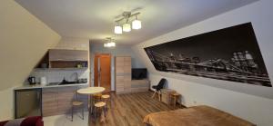 a living room with a kitchen and a dining room at Willa na Bartkowym Wierchu in Gliczarów Górny