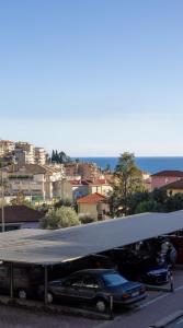 a parking lot with cars parked under a canopy at Maison de Pi Sanremo in Sanremo