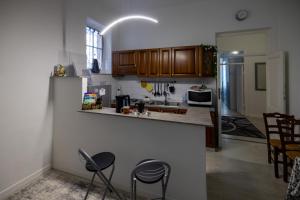 a kitchen with a counter and some chairs in it at Maison de Pi Sanremo in Sanremo