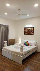a bedroom with a large bed in a room at Feel Goa at Poolview 2BHK Luxury Apartment in Arpora