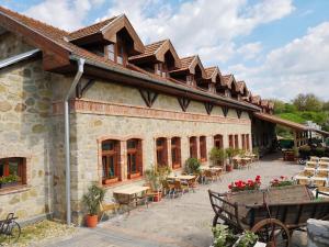 a building with tables and chairs on a patio at István Pince a penzión in Šahy