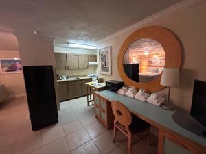 a kitchen with a counter with a mirror on it at Sea Vista Motel in New Smyrna Beach +47 photos
