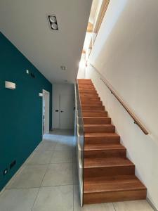 a staircase in a house with a green wall at Eco-Chalet Matschiedl in Tratten