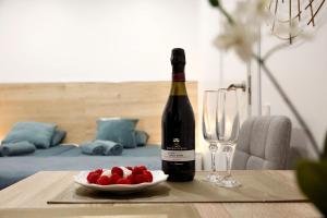 a bottle of wine and a plate of strawberries on a table at Heaven Sea in Alicante