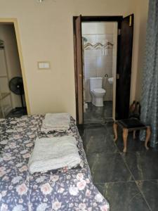 a bedroom with a bed and a bathroom with a toilet at palm nature lodge in Sanyang +38 photos