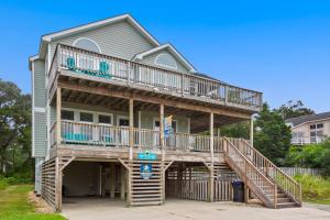 a large house with two decks and a balcony at 2000 - Pipers Paradise in Duck