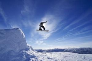 a man flying through the air on a snowboard at St Croix Suites - St Croix Falls in Saint Croix Falls