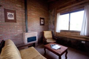 a living room with a couch and a fireplace at Aldea Serrana in Nono