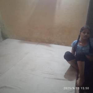 a woman sitting on the floor in a room at Balaji Shridham in Jāmb