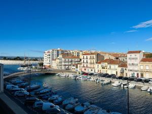 a group of boats parked in a marina with buildings at Sète en couleurs in Sète