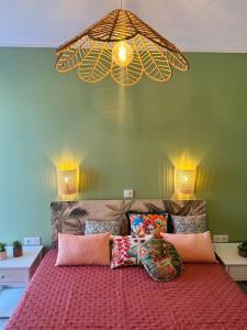 a bedroom with a bed with a chandelier above it at Sète en couleurs in Sète +21 photos
