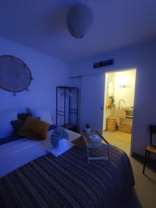 a blue bedroom with a large bed and a bathroom at O'me Wally in Galargues